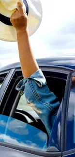 Arm extending from car with waving hat.