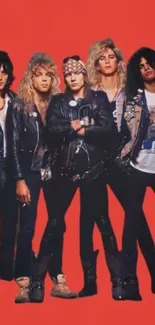 80s rock band in leather jackets on vibrant red backdrop.