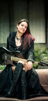 Woman with guitar in black outfit on couch in rustic setting.