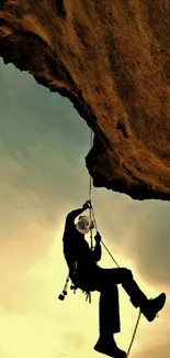 Silhouette of a rock climber against a sunset sky.