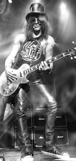 Black and white photo of rock guitarist on stage with electric guitar.