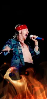 Rock performer with red bandana singing on stage.