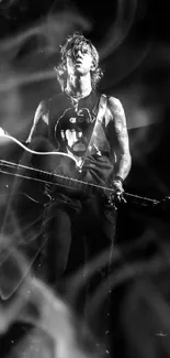 Black and white image of a rock star holding an electric guitar.