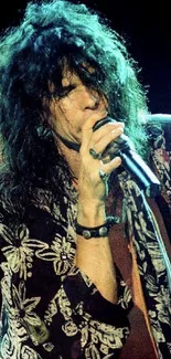 Rock star passionately performing on stage with microphone.