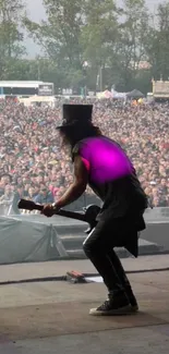 Guitarist performing on stage at a rock festival with a vibrant purple highlight.