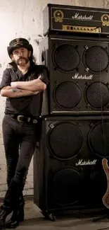 Rock musician with Marshall amp stack and guitar in industrial room.