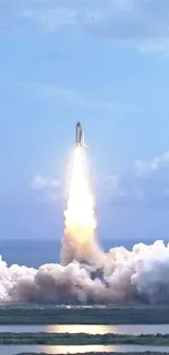 Rocket launch soaring through clouds against a vibrant blue sky.