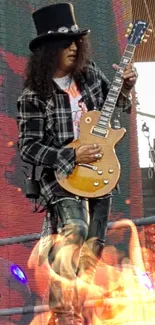 Rock guitarist performing on stage with electric guitar and plaid outfit.