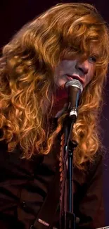 Guitarist passionately performing on stage with a microphone and guitar.