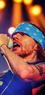 Rockstar passionately singing on stage with blue bandana and microphone.