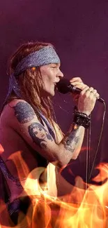 Rockstar singing passionately on stage with tattoos and purple backdrop.