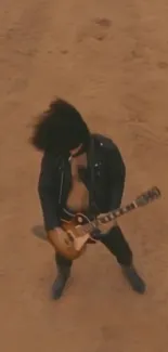 Guitarist performing passionately in a desert setting.