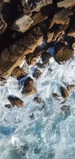 Aerial view of rocky coastline with ocean waves crashing.