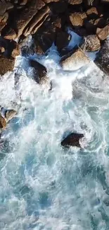 Aerial view of waves crashing against rocky coastline.