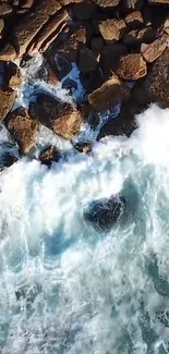 Aerial view of rocky coastline with crashing ocean waves.