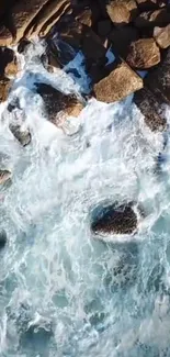 Aerial view of ocean waves crashing on a rocky coastline.