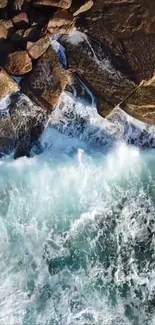 Aerial view of waves hitting a rocky coastline with vibrant blue water.