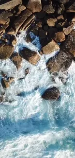 Aerial view of rocky coastline with crashing blue waves.