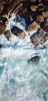 Aerial view of ocean waves crashing against rocky shoreline.