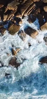 Aerial view of ocean waves crashing against rocky shore.