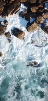 Aerial view of ocean waves crashing against rocky shore.