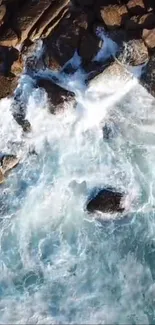 Aerial view of ocean waves crashing on rocky shore.