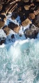 Aerial view of ocean waves crashing against rocky shore.