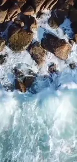 Aerial view of ocean waves crashing on rocky shore, perfect for mobile wallpaper.