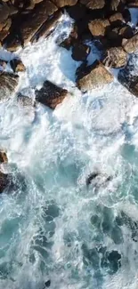 Aerial view of waves crashing against rocks in a scenic seascape.