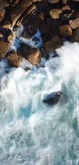 Aerial view of waves crashing on rocky shore.