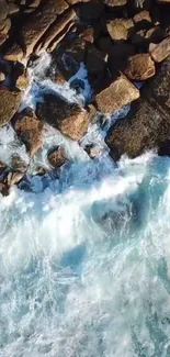 Aerial view of ocean waves crashing on a rocky shore.