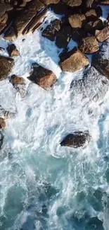 Aerial view of ocean waves crashing onto a rocky shoreline, showcasing nature's power.