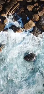 Aerial view of waves crashing on a rocky shoreline, capturing natural beauty.