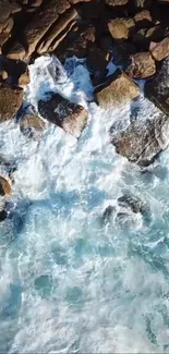 Aerial view of ocean waves crashing on rocky shoreline.