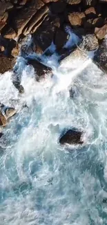 Aerial view of waves crashing against a rocky shoreline.