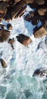 Aerial shot of rocky coastline with waves crashing against the rocks.