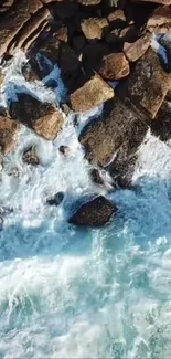 Aerial shot of waves crashing on a rocky shoreline.