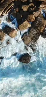 Aerial view of rocky shoreline with crashing ocean waves.