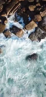 Aerial view of rocky shoreline with blue ocean waves.