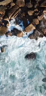 Aerial view of rocks and waves crashing on a coastline, capturing nature's beauty.