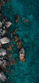 Aerial view of rocky shoreline with turquoise water.