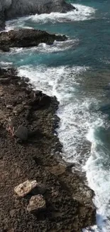 Aerial view of rocky shoreline with crashing waves.