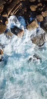 Aerial view of ocean waves crashing against rocky shore.