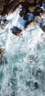 Aerial view of ocean waves hitting rocky shoreline, capturing nature's raw power.