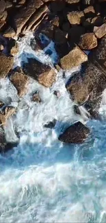 Mobile wallpaper of crashing ocean waves on a rocky shoreline.