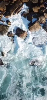 Aerial view of rocky shoreline with ocean waves crashing.