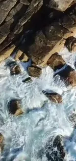 Aerial view of ocean waves crashing against a rocky shoreline.