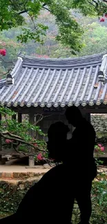 Silhouette couple in an Asian garden setting with serene green scenery.