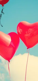 Romantic heart-shaped balloons float in a clear blue sky.