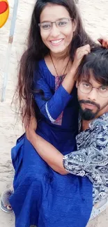 Romantic couple at the beach with a heart emoji and blue attire.